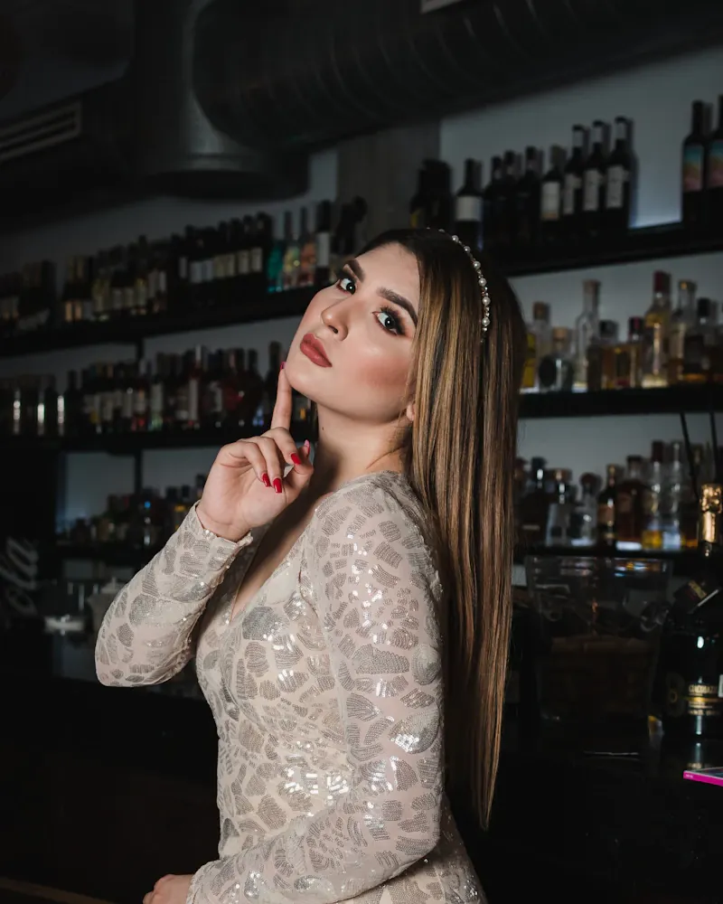 Woman with a cocktail in a dimly lit downtown bar