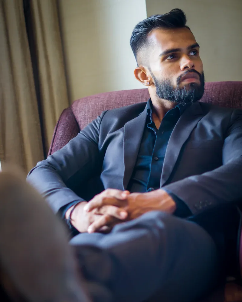 Man in a tailored jacket in a resort lobby lounge